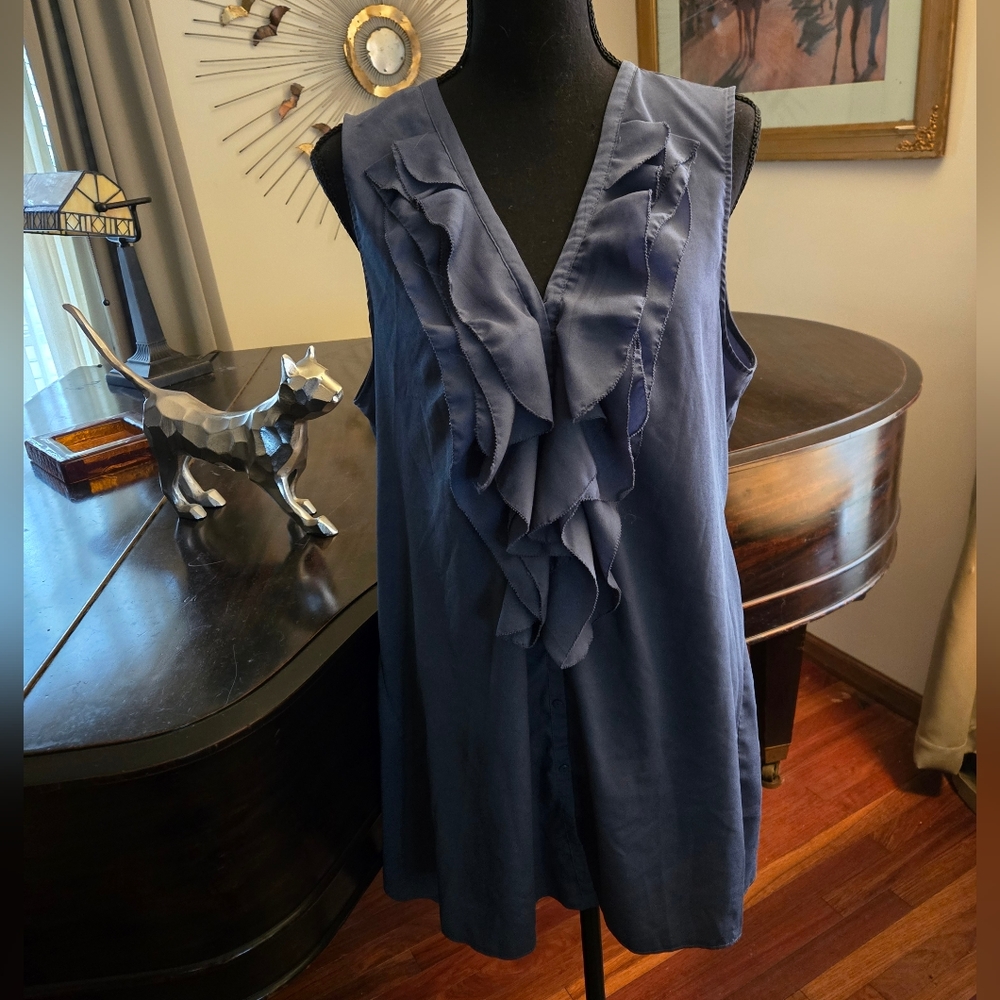 Sleeveless button-down blouse with ruffled front.